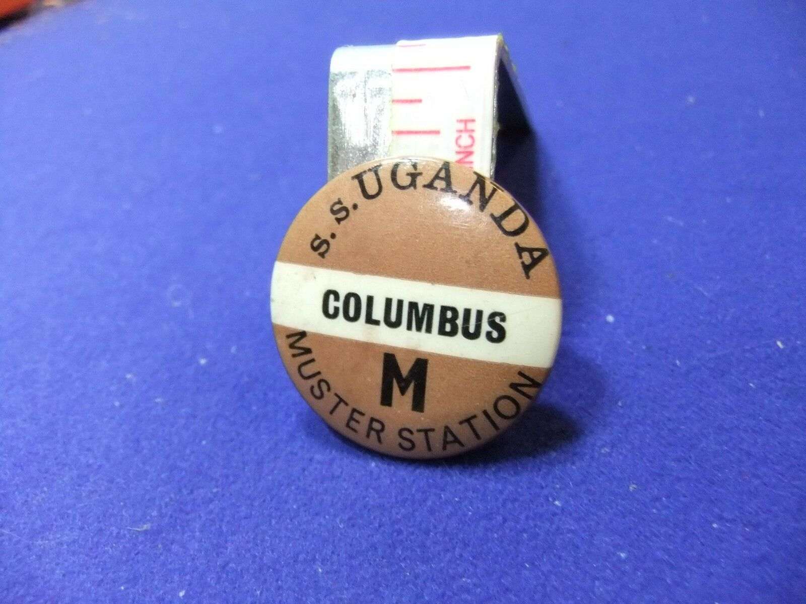 tin-badge-ss-uganda-columbus-M-muster-station.jpg